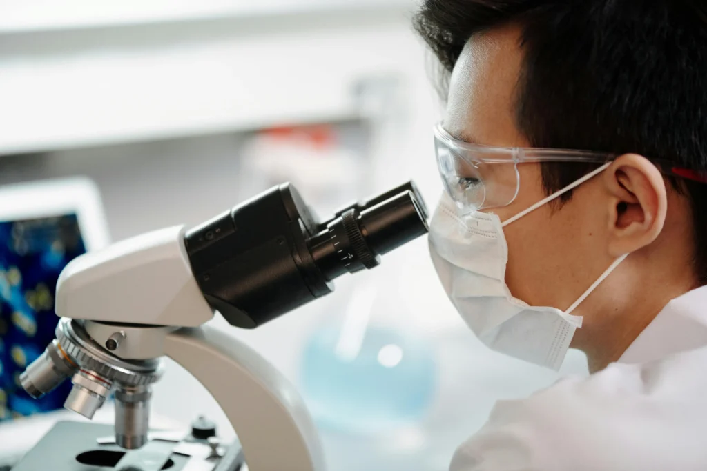 Scientist looking through microscope